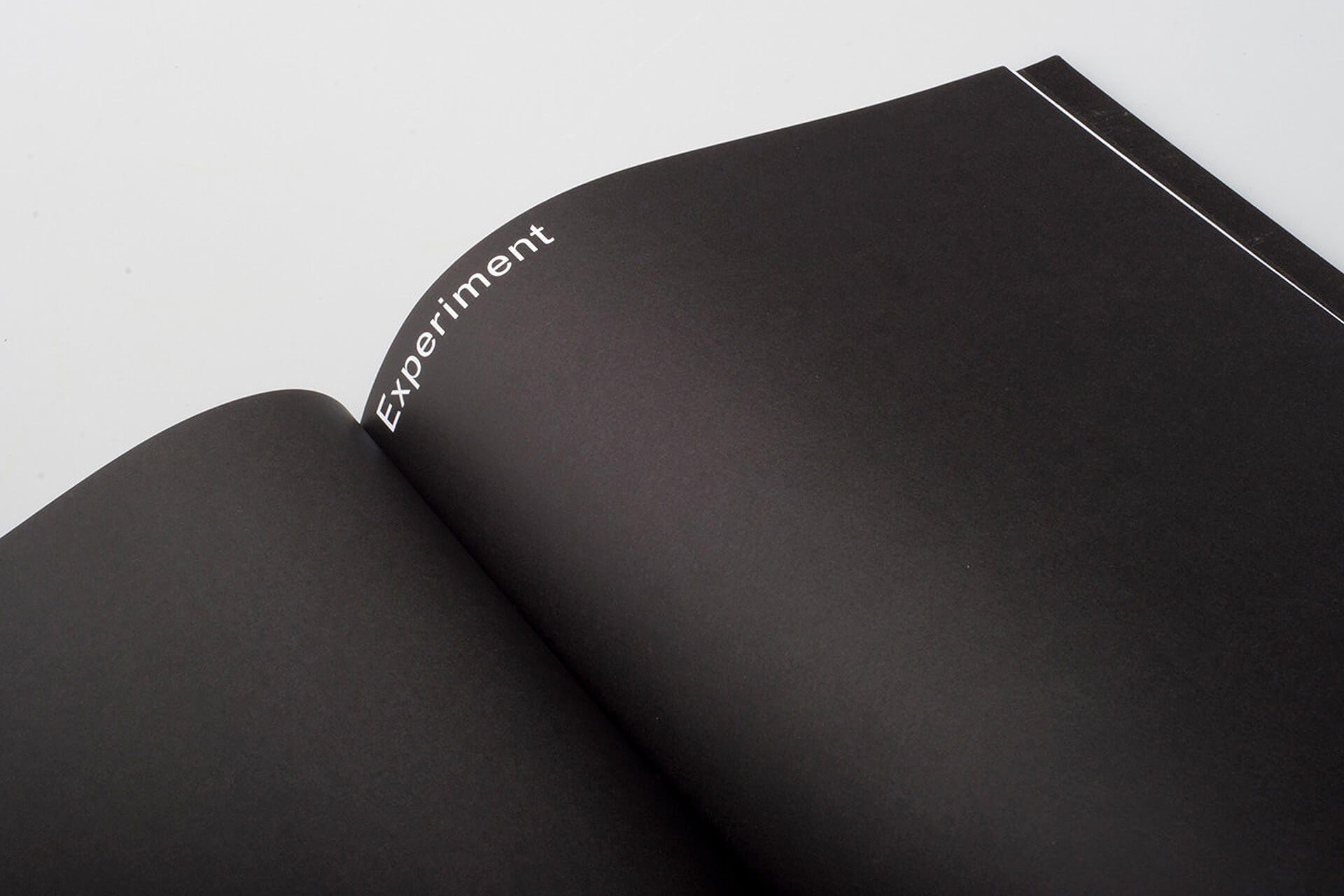 Black notebook open, says "Experiment."