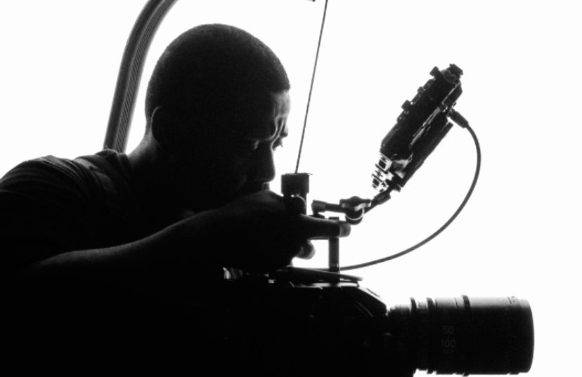 A man working on an object in the air.